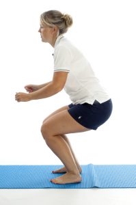 physiotherapist bending down in a squat position